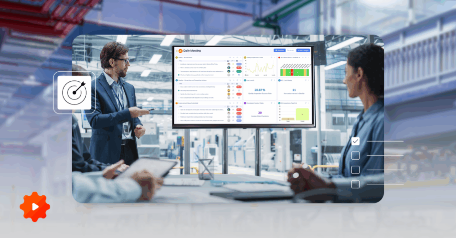 Manager using a digital MDI board for Visual Management to review performance metrics with the team in an industrial office.